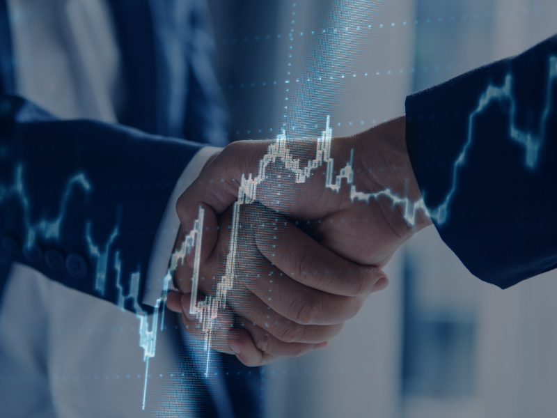 A handshake overlaid on a graph trending up