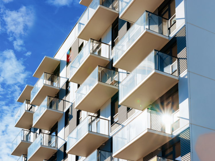 A row of apartment suite balconies on a sunny day