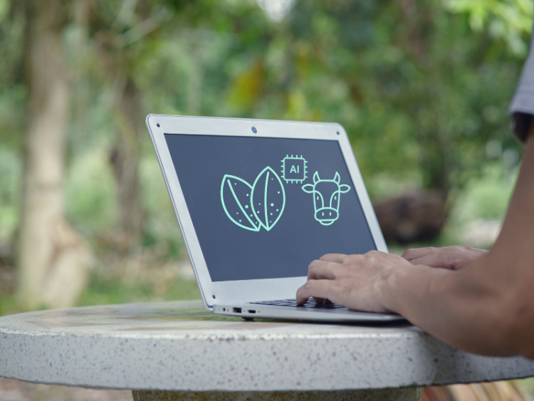 A laptop with a cow and AI symbol on the screen