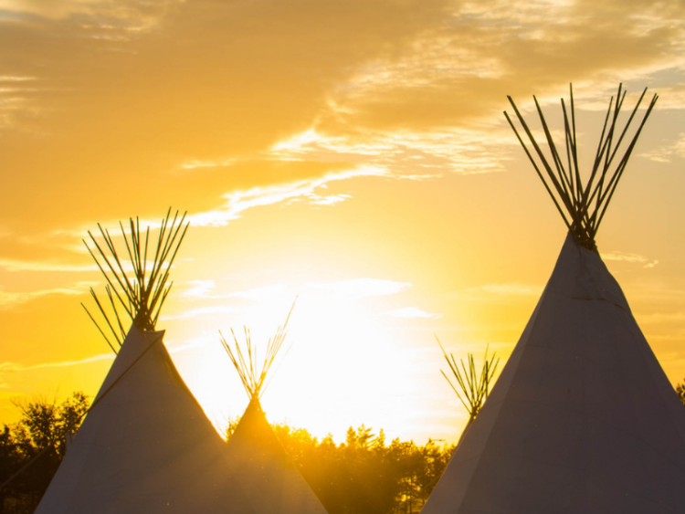 Four teepees at dawn