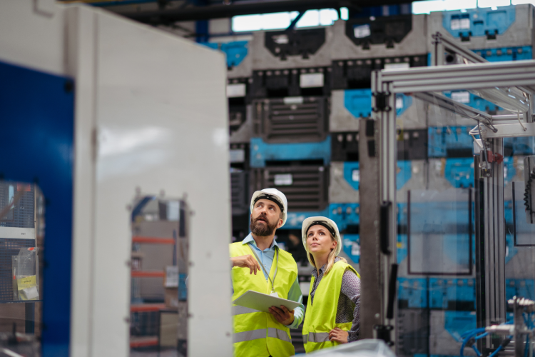 Industrial Team Analyzing Data in High Tech Manufacturing Plant
