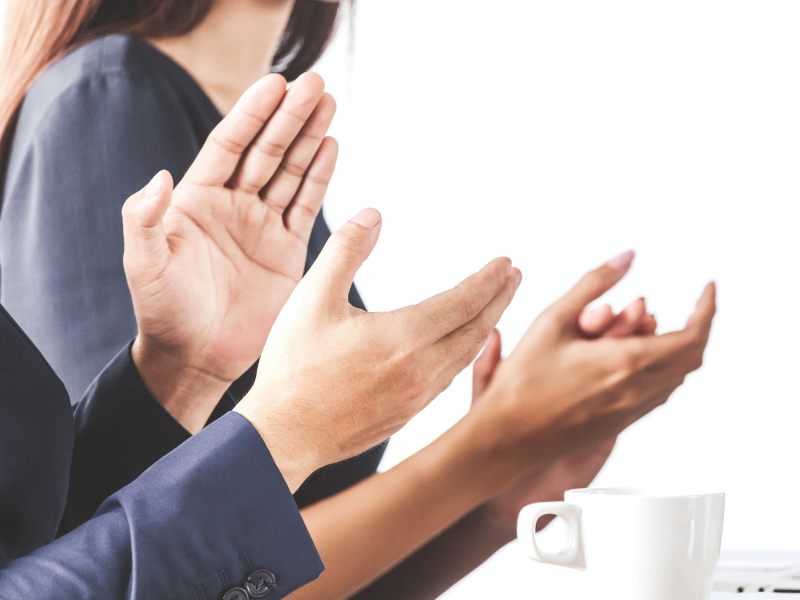 Hands clapping over a white background