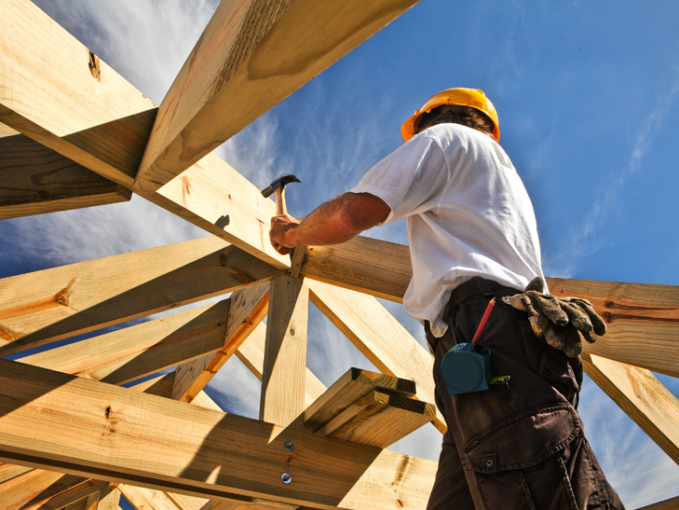 A construction worker working on a building frame