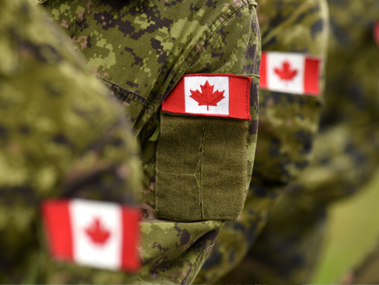A closeup of a Canadian flag on an armed services uniform