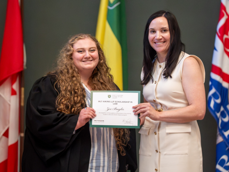 Zoe Baylis being presented with her award by MLT Aikins partner Erin Eccleston