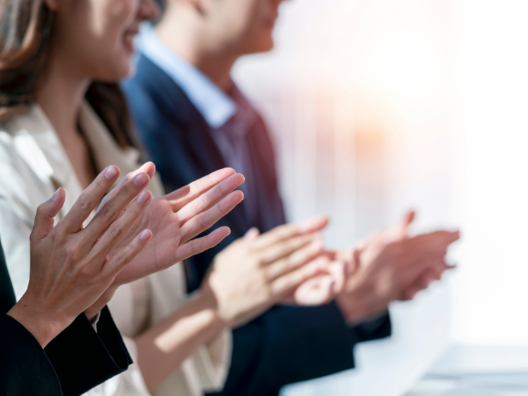 A group of business professionals applauding
